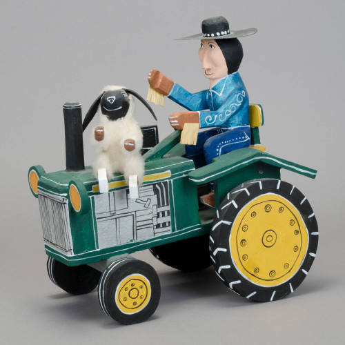 Man and sheep on tractor