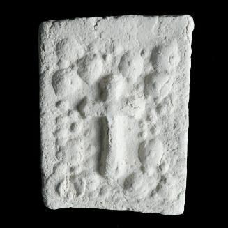 Sacred clay tablet with floral arch enclosing cross in center