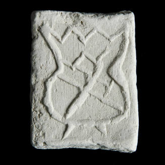 Sacred clay tablet with design resembling a coat of arms