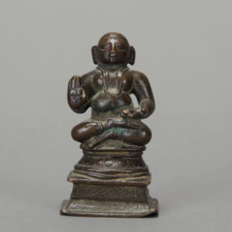 Seated priest sculpture