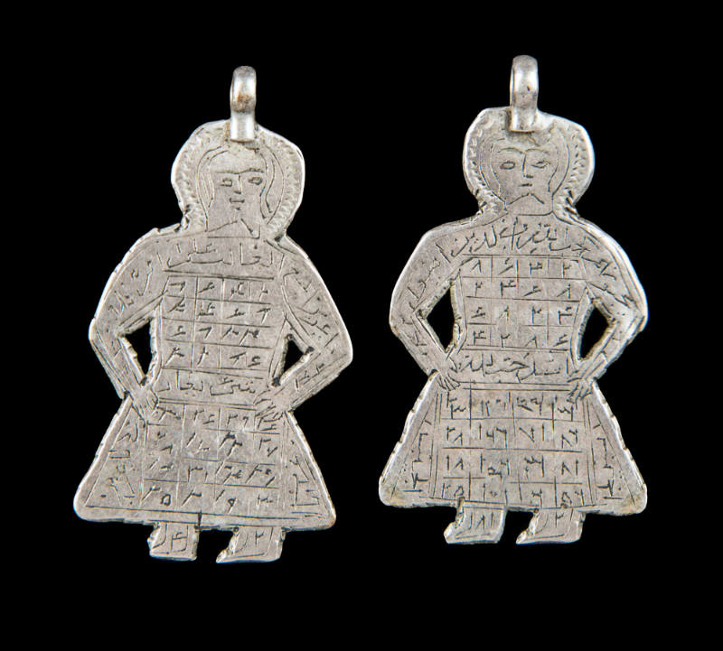 Pair of figurative pendants inscribed with magic squares containing Arabic writing