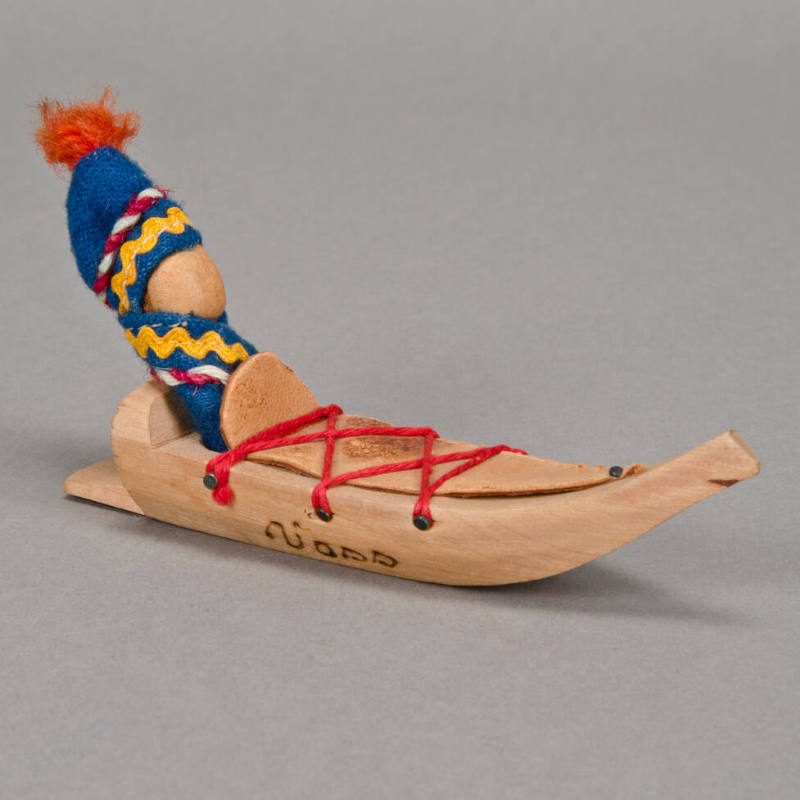 Infant Doll in Sled