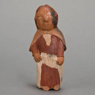 Figural whistle, woman holding skirt