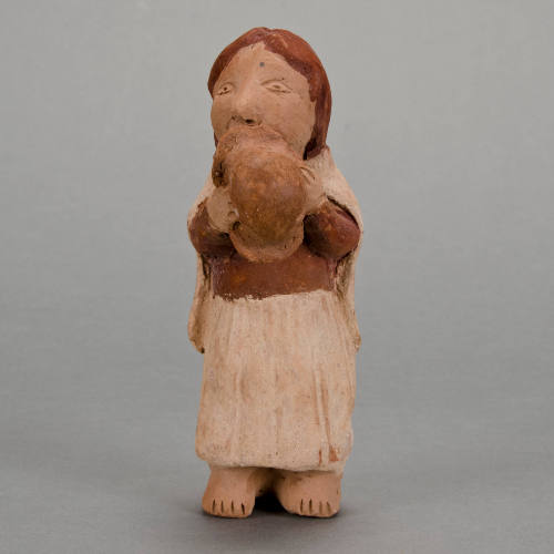 Figural whistle, woman holding hat