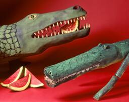 Life size hand-carved wood alligator and carved, assembled figure of a crocodile.  