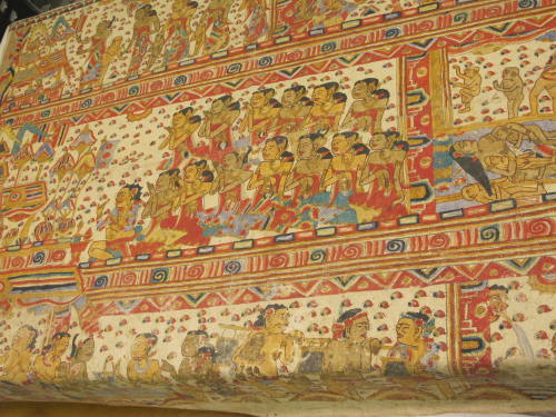 Painting depicting village and ritual life in Bali, including temple offerings and a Barong dance
