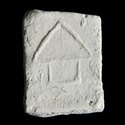 Sacred clay tablet with simple architectural design 