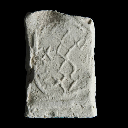 Sacred clay tablet with complex, linear, abstract design