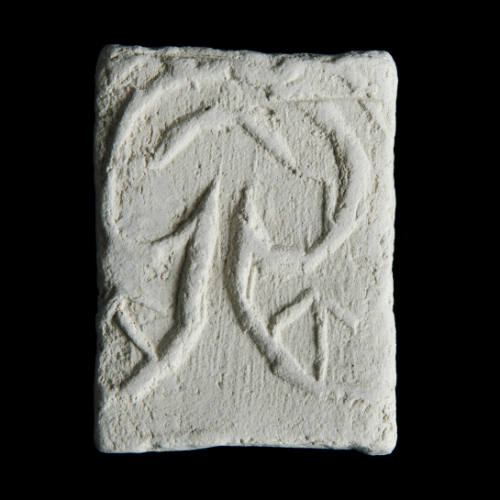 Sacred clay tablet with linear design suggesting a tree