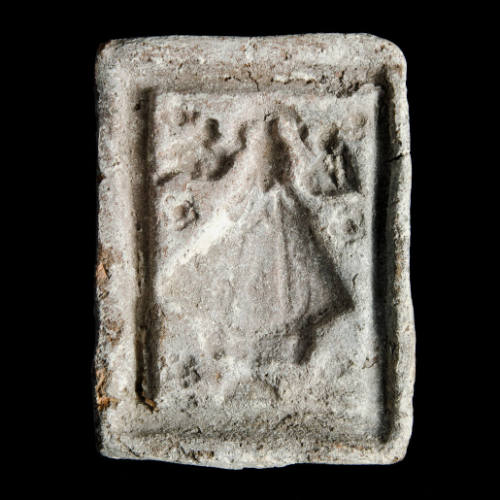 Sacred clay tablet mold of Virgin with five-petaled flowers at sides