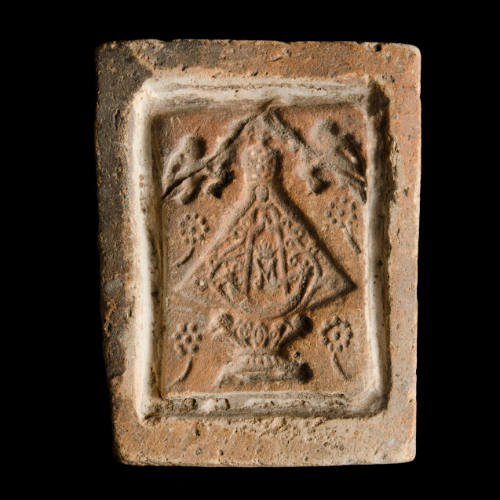 Sacred clay tablet mold of Virgin with many-petaled flowers