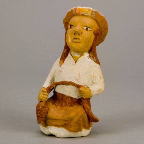 Figural whistle, woman spinning wool